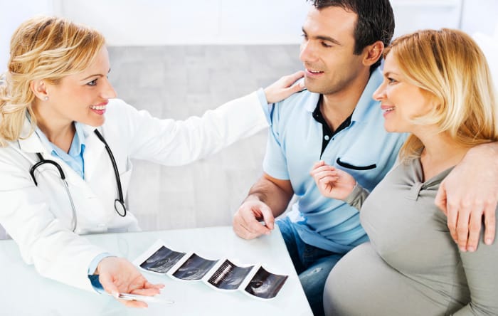 Young family in consultation with a doctor about pregnancy. [url=http://www.istockphoto.com/search/lightbox/9786662][img]http://dl.dropbox.com/u/40117171/medicine.jpg[/img][/url] [url=http://www.istockphoto.com/search/lightbox/9786778][img]http://dl.dropbox.com/u/40117171/family.jpg[/img][/url]