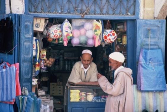 Men chatting at shop, Essaouira, Morocco