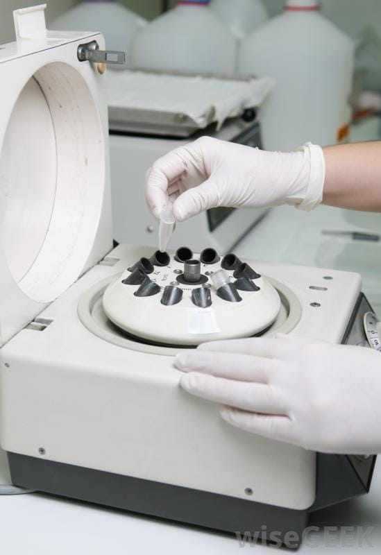 scientist-placing-a-test-tube-in-a-centrifuge